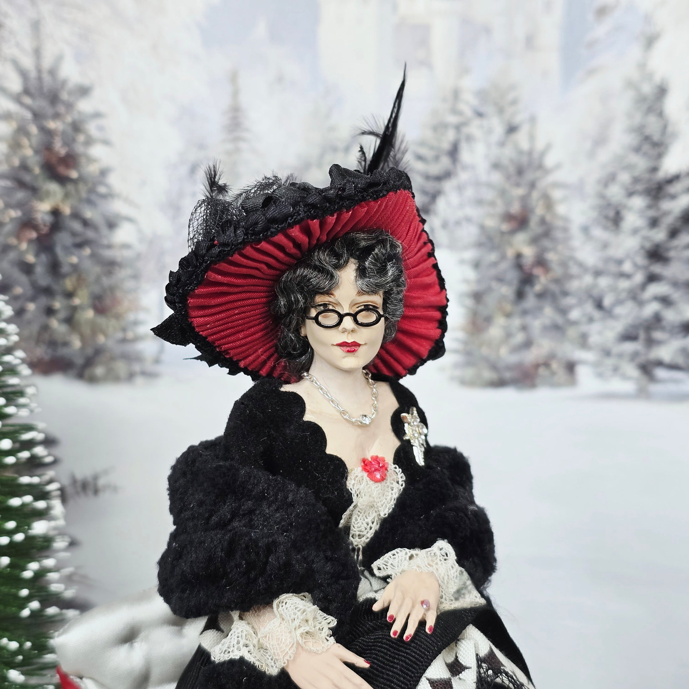 “Winter Lady” Doll in a black and red outfit with a snowy background