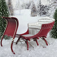 Load image into Gallery viewer, Red sleigh with white seats in a snowy landscape
