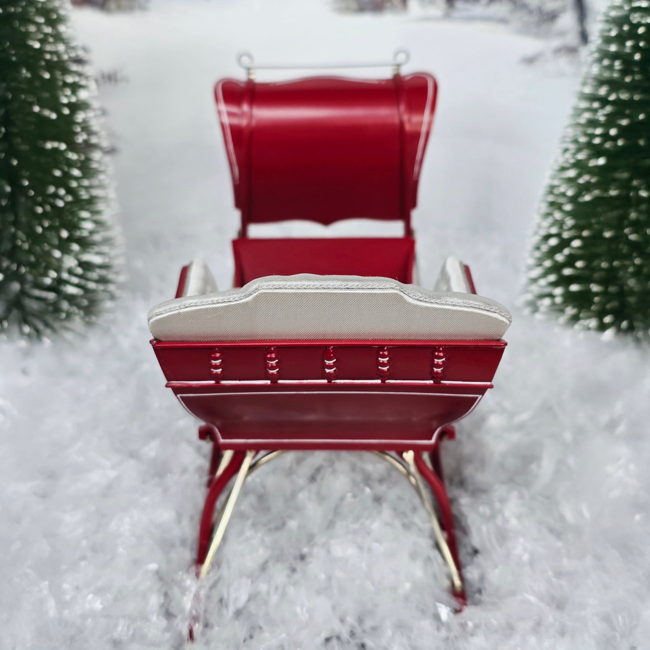 Red sleigh with white seats in a snowy landscape, top view