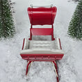 Load image into Gallery viewer, Red sleigh with white seats in a snowy landscape, top view #2
