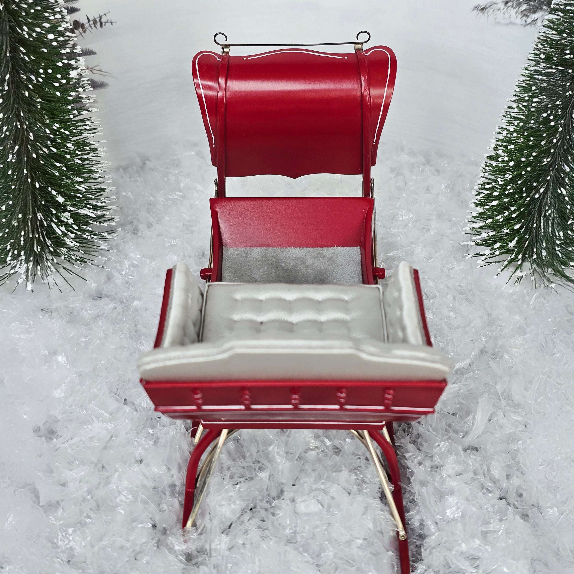 Red sleigh with white seats in a snowy landscape, top view #2