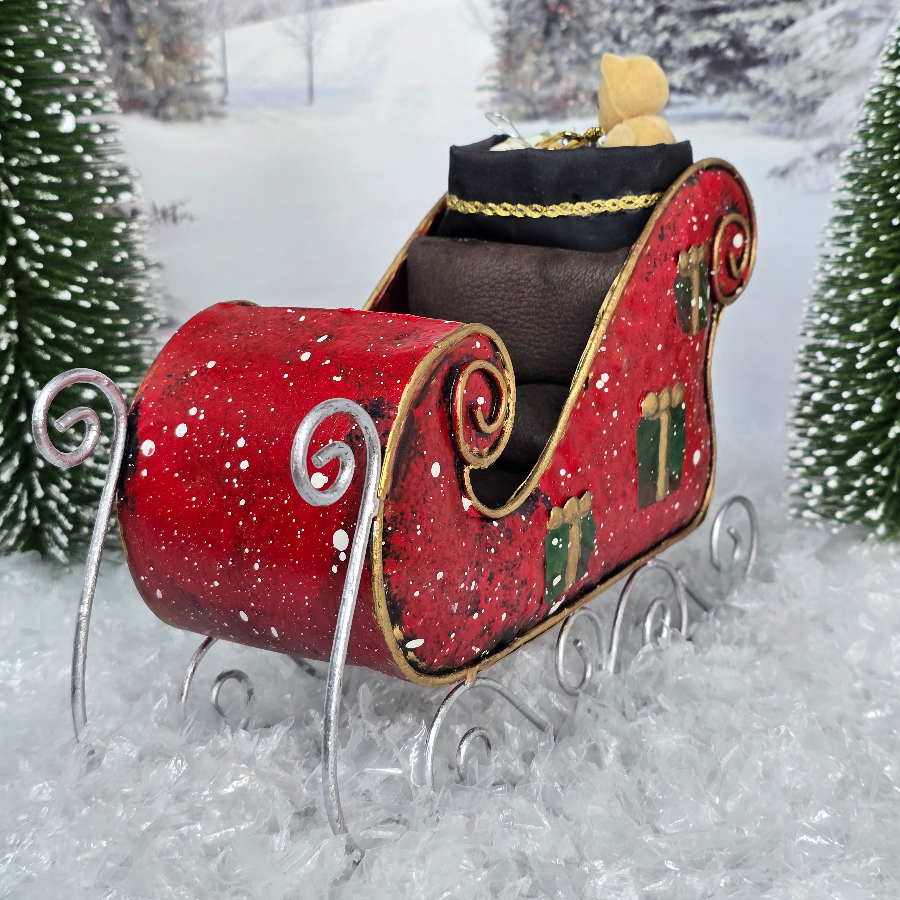 Red Christmas sleigh with decorative elements on a snowy background