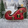 Load image into Gallery viewer, Decorative red sleigh with gold details in a snowy landscape, side view
