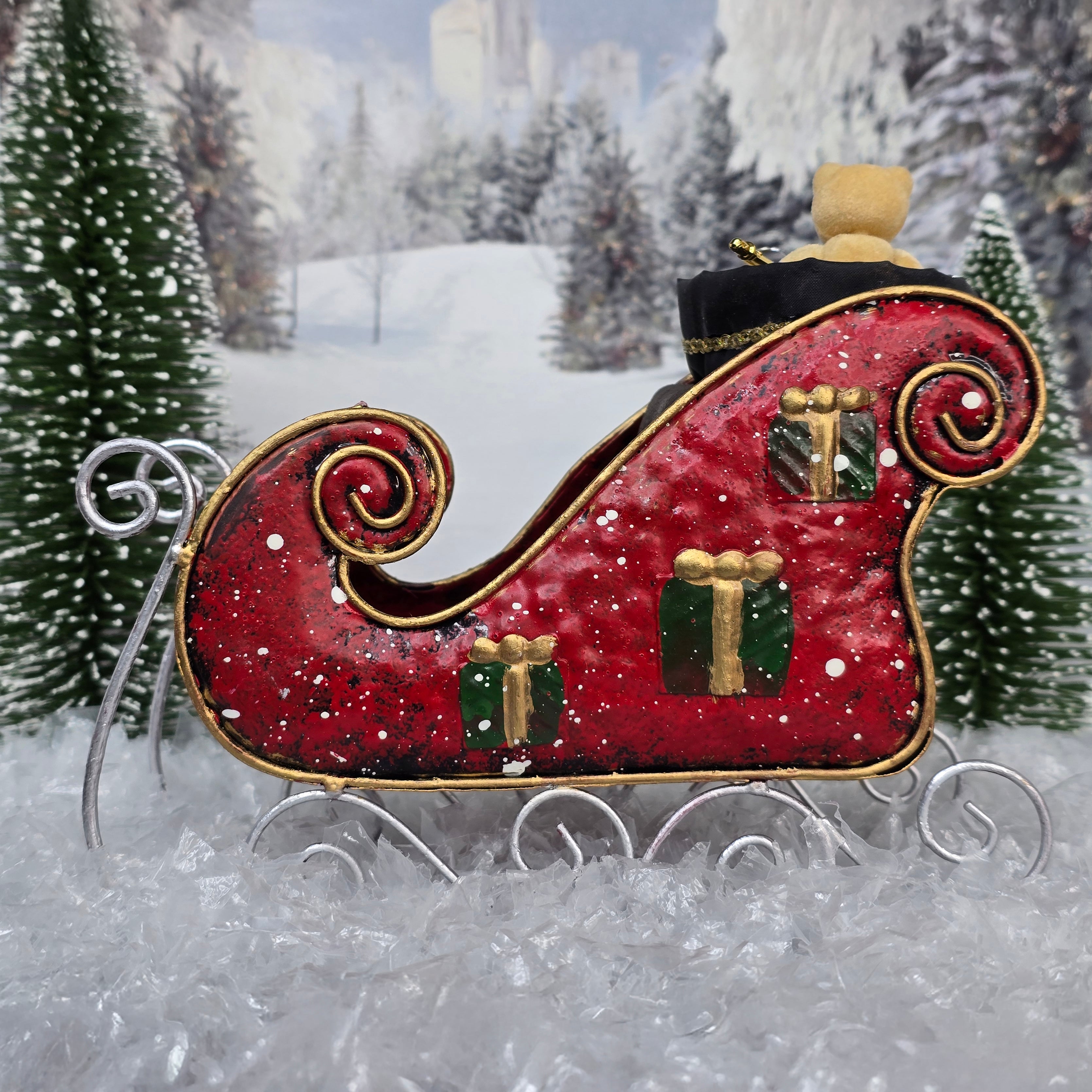 Decorative red sleigh with gold details in a snowy landscape, side view