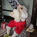 Load image into Gallery viewer, Santa Claus doll in a festive setting with a Christmas tree and presents.
