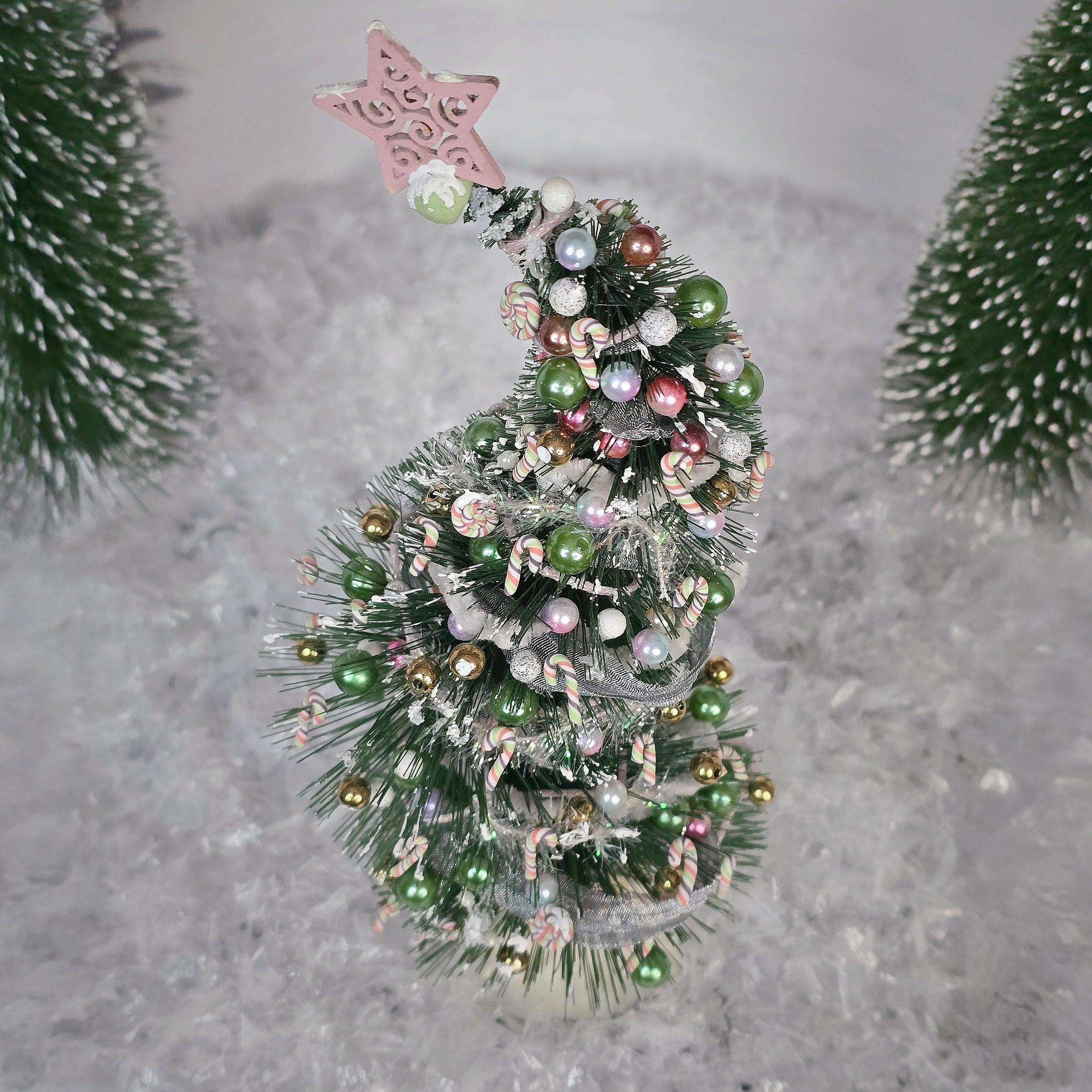 Decorative Christmas tree with colorful ornaments on a textured gray background