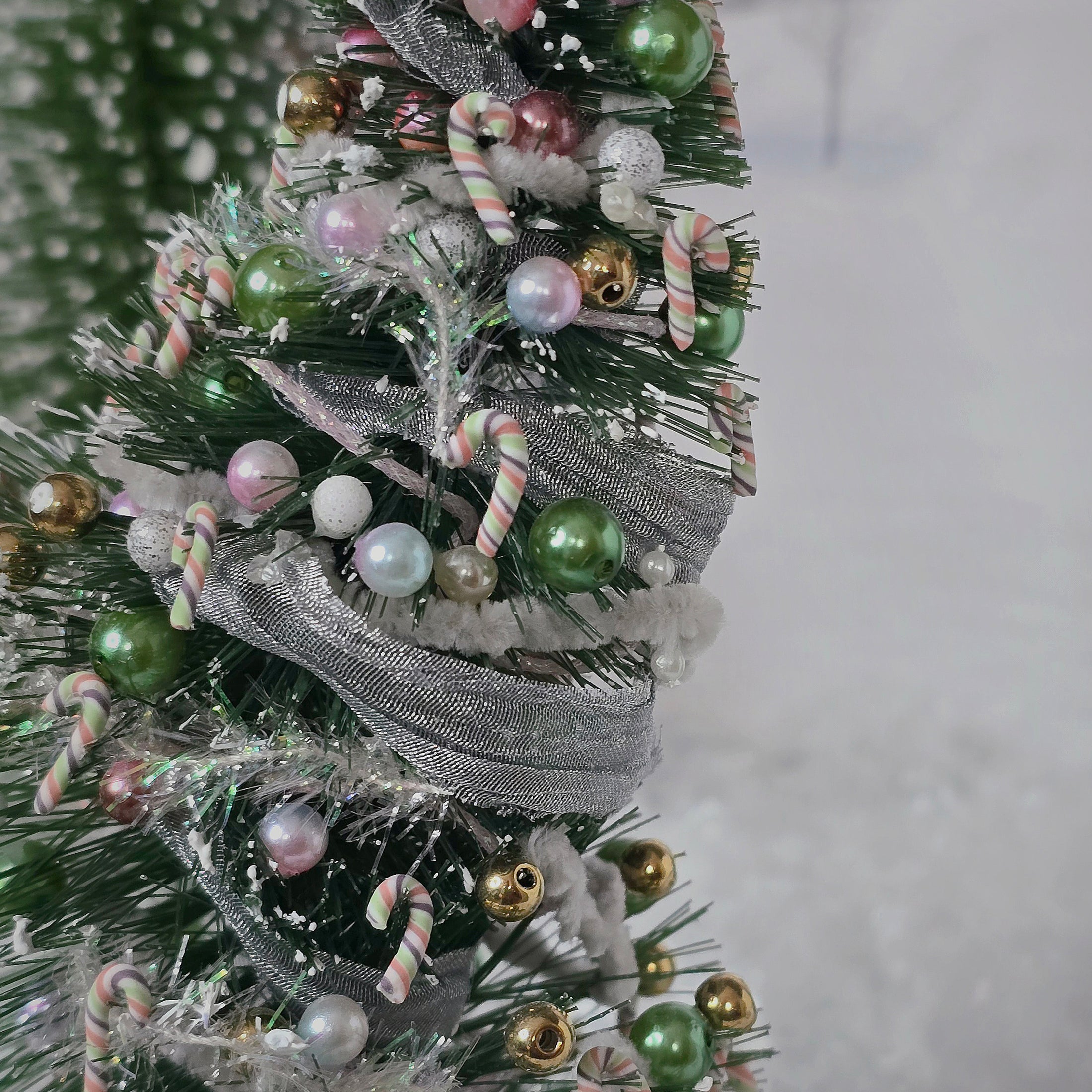 Decorative Christmas tree with ornaments on a plain background