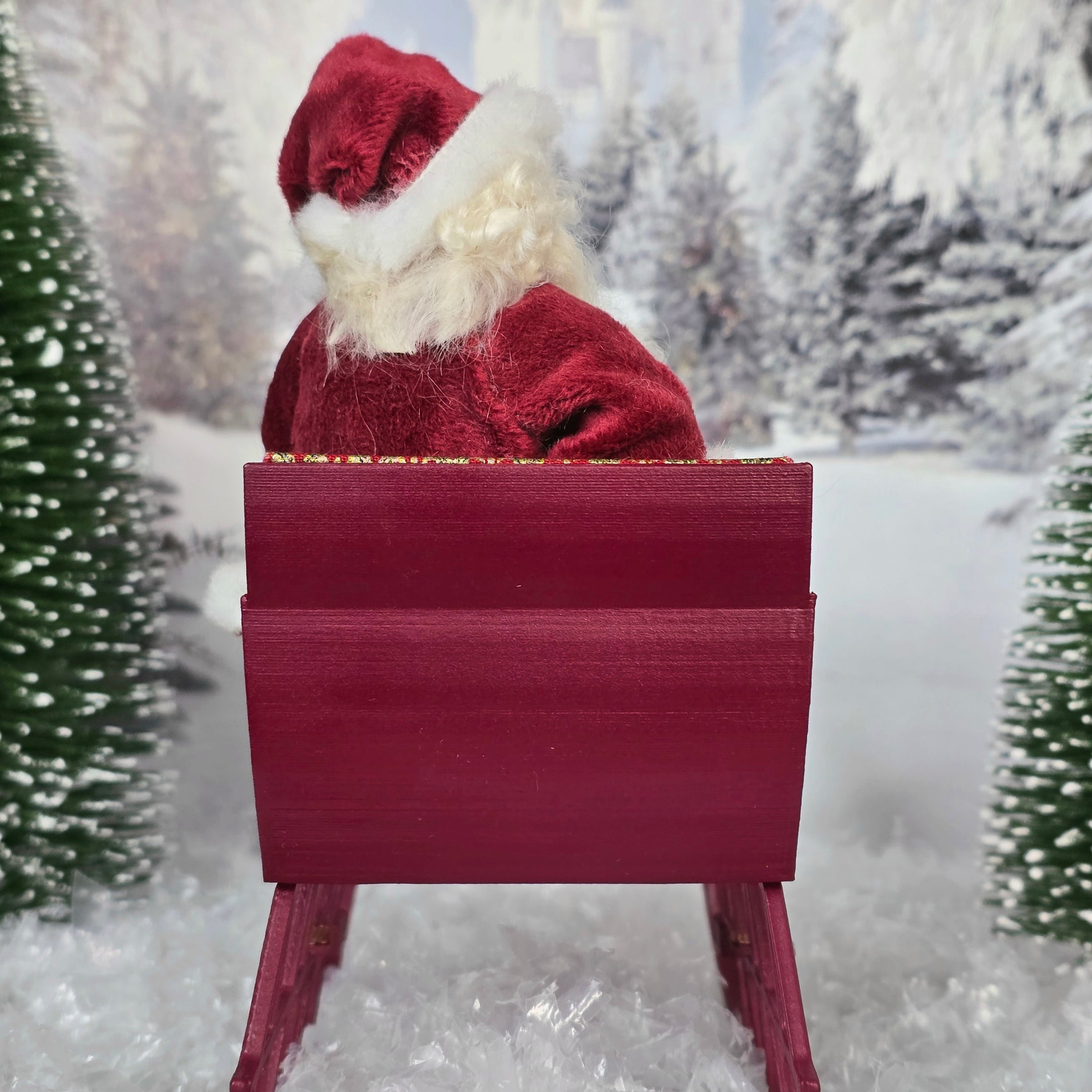 the back of a Santa dollhouse doll in his red sleigh