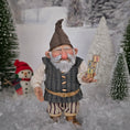 Load image into Gallery viewer, Sharon Cariola Elf dollhouse doll holding wooden blocks in a snowy landscape with a snowman and trees.

