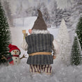 Load image into Gallery viewer, Sharon Cariola Elf dollhouse doll in a winter scene with snow-covered trees and a small snowman.
