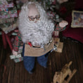 Load image into Gallery viewer, Dollhouse Doll Santa Claus with a long white beard and tool belt,  in a festive setting

