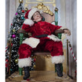 Load image into Gallery viewer, Santa dollhouse doll sitting in a throne in a festive setting with a decorated Christmas tree.
