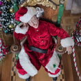 Load image into Gallery viewer, Santa dollhouse doll in a festive setting with Christmas trees.
