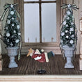 Load image into Gallery viewer, Decorative Christmas scene with two small trees, a flying Santa figure, and a star on a wooden floor.
