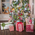 Load image into Gallery viewer, Decorated Christmas tree with ornaments and presents on a wooden floor.
