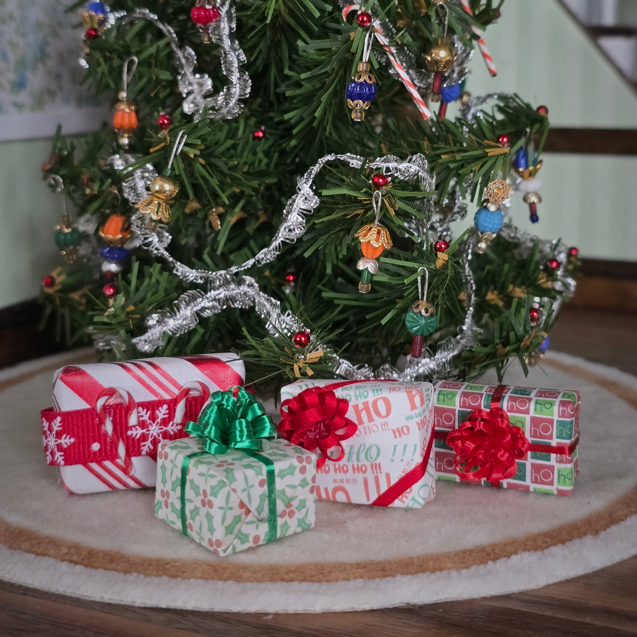 group of miniature dollhouse wrapped Christmas gifts