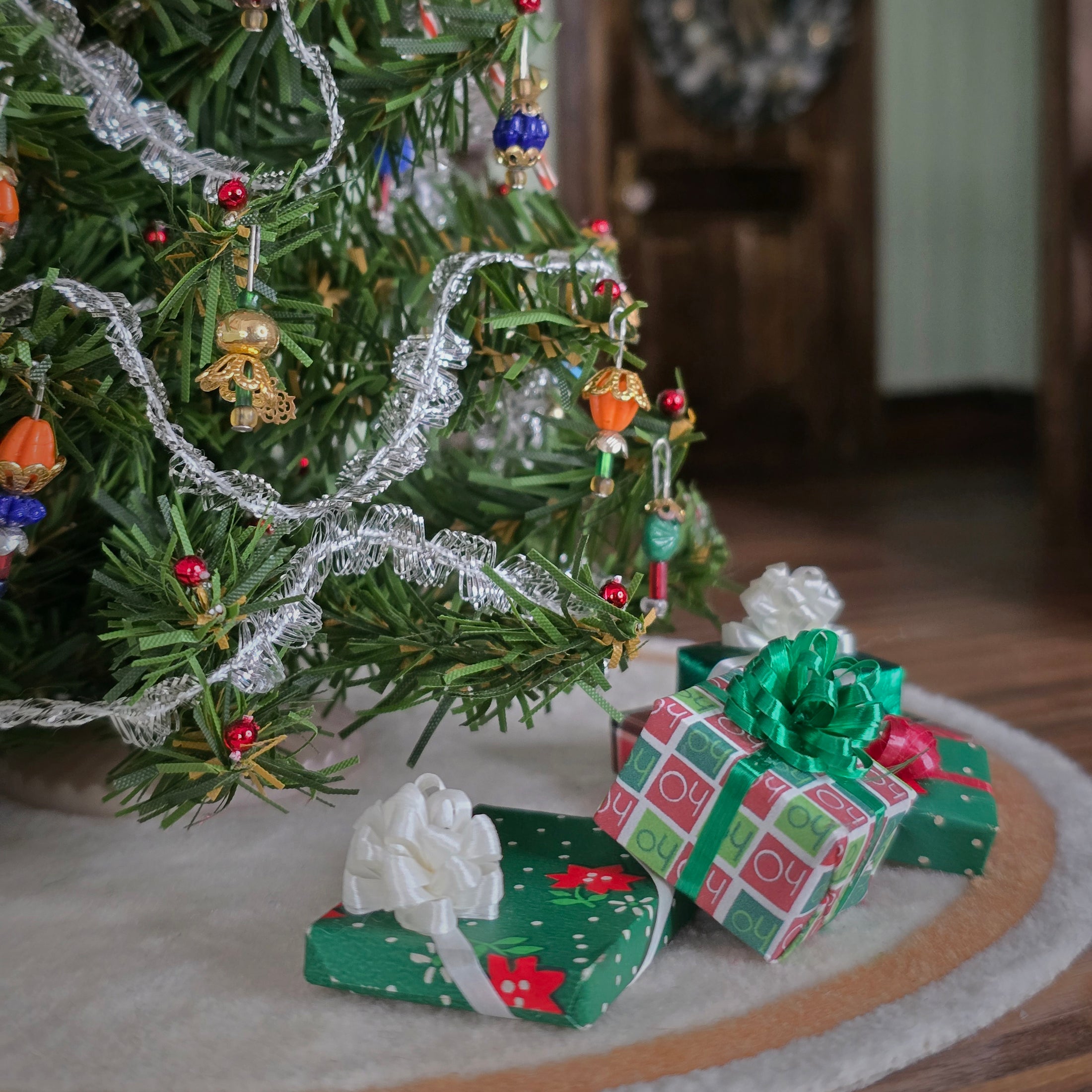 miniature dollhouse wrapped gifts under the tree