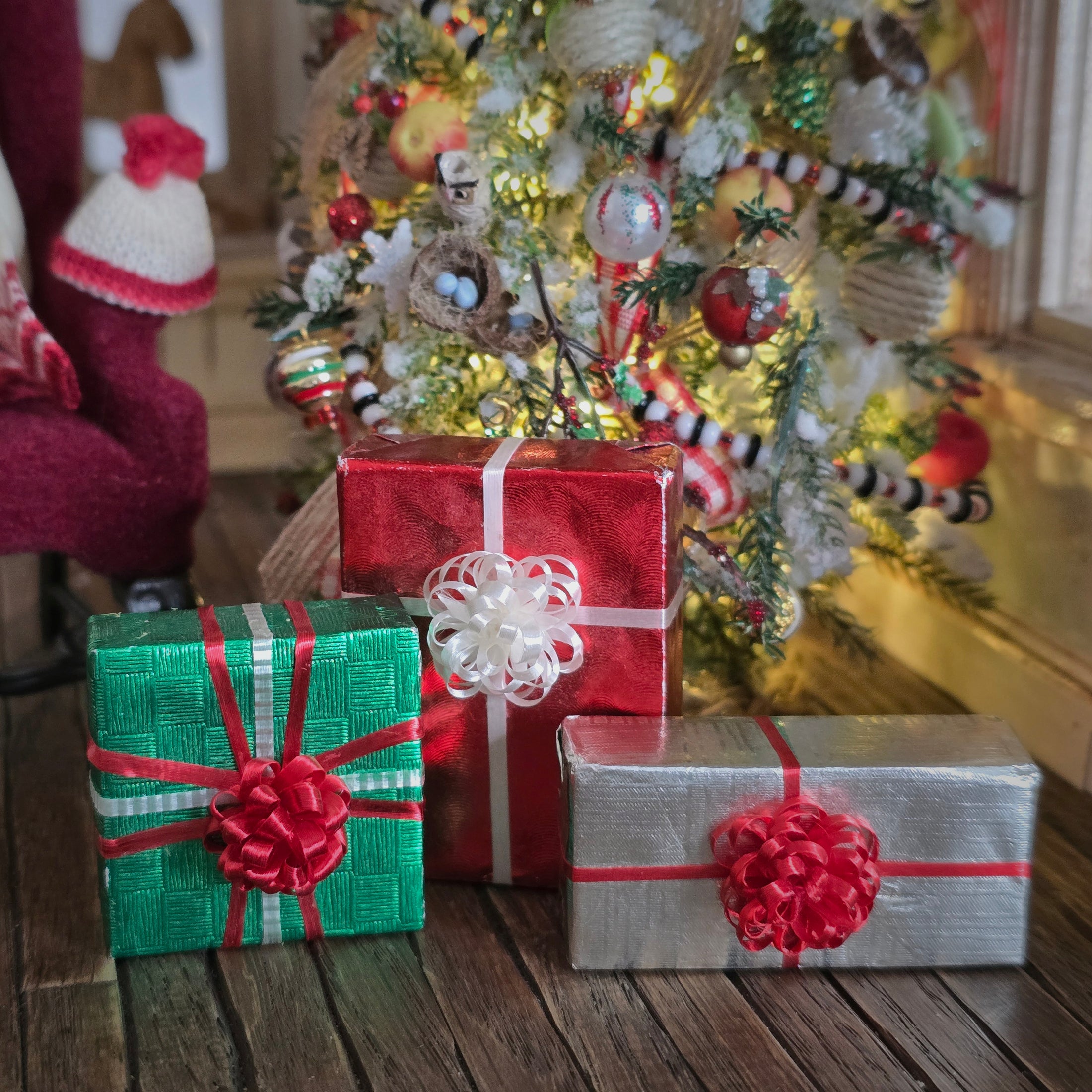 Decorative Christmas scene with wrapped gifts and a tree in a room.