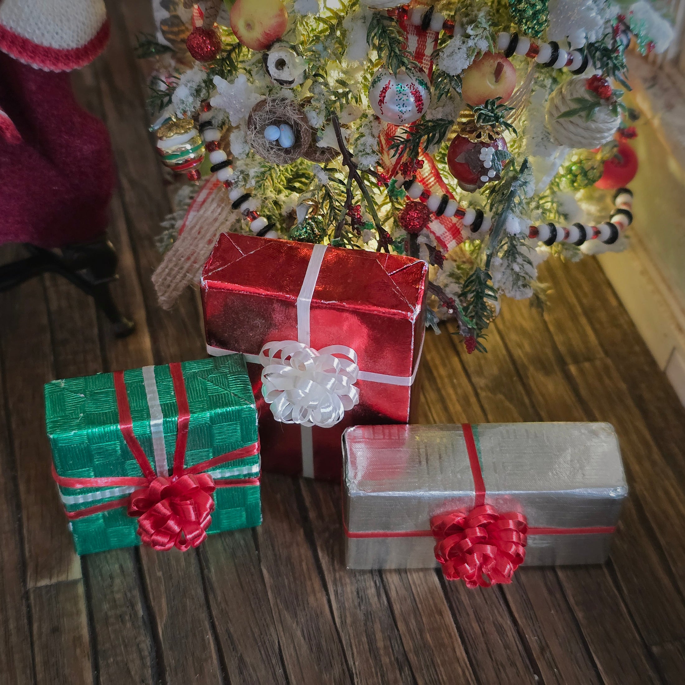 Decorative Christmas scene with wrapped gifts and a tree in the background.