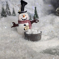 Load image into Gallery viewer, Decorative snowman miniature with a top hat and scarf, standing near a small bucker on a snowy background.
