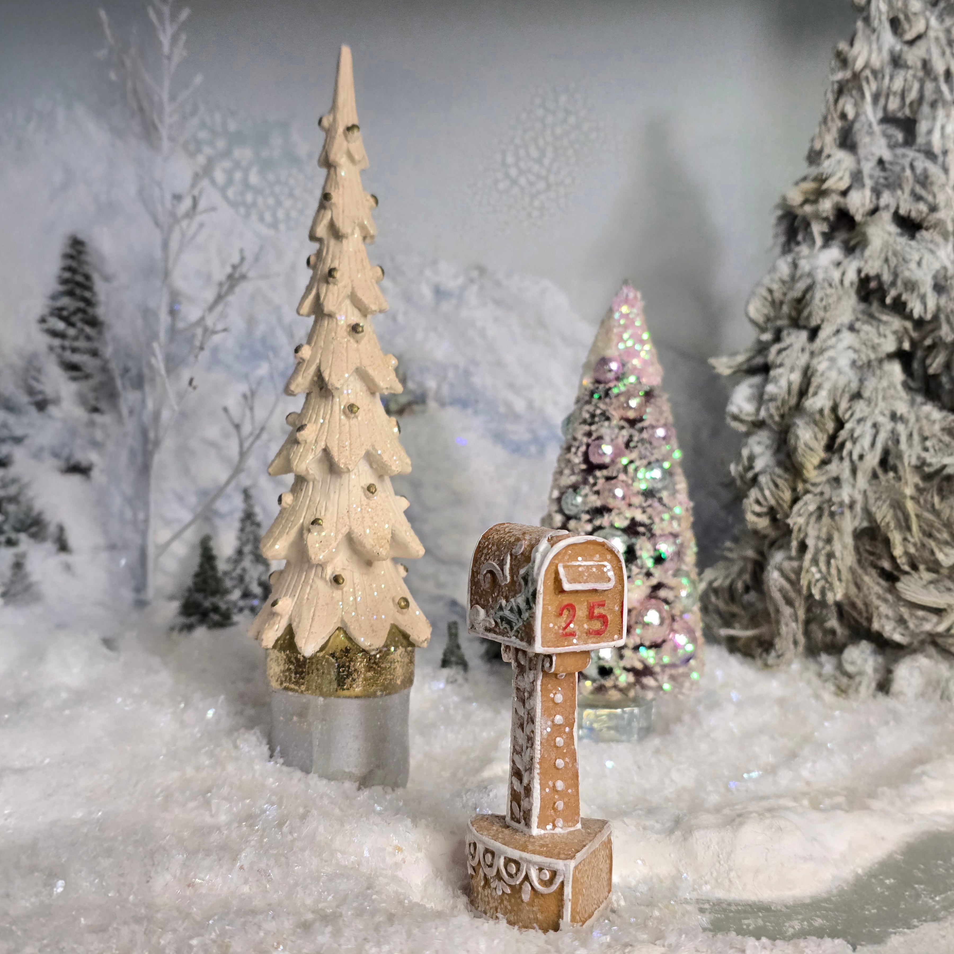 Decorative miniature Christmas trees and mailbox in a snowy landscape