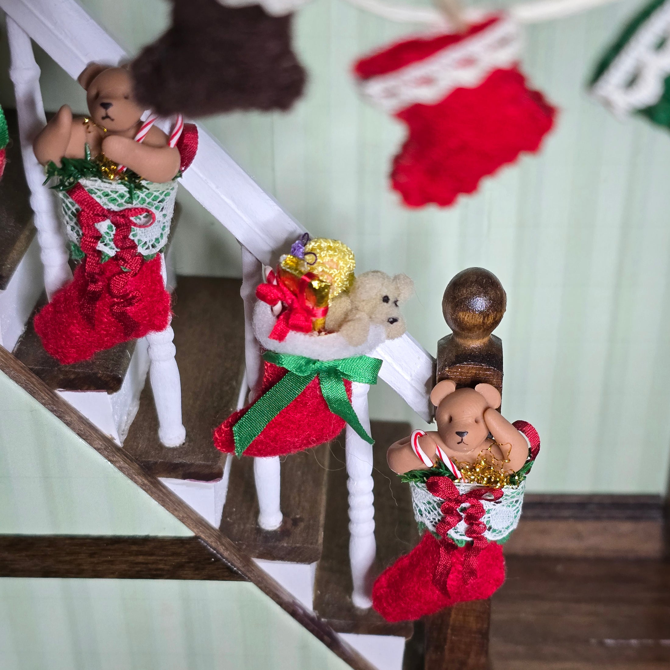 Decorative Christmas stockings with teddy bears on a staircase
