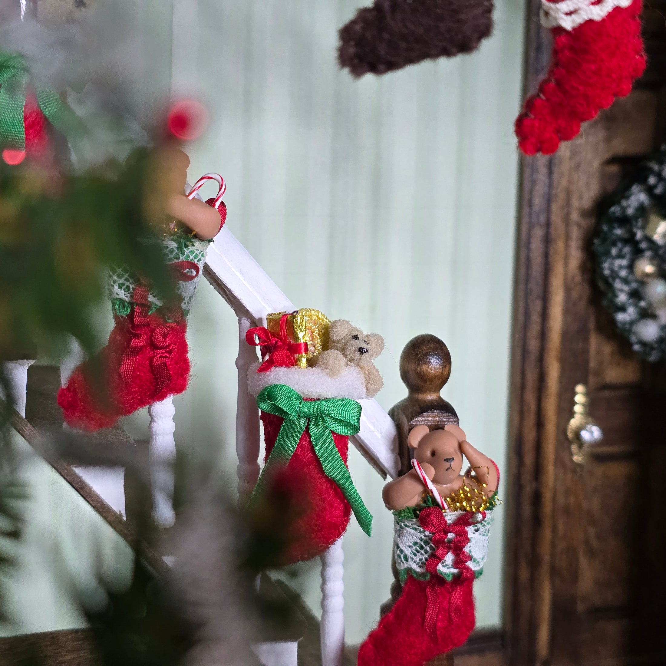 Decorative Christmas stockings with festive elements on a wooden surface.