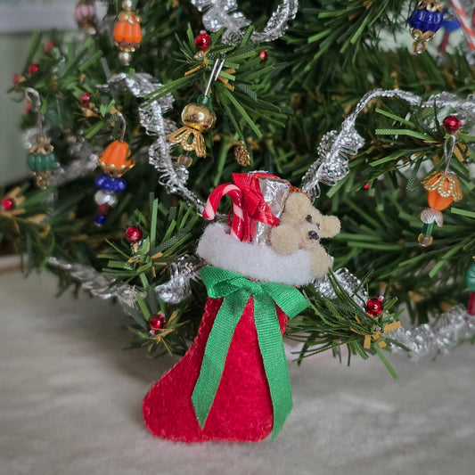 miniature dollhouse stocking in front of a tree