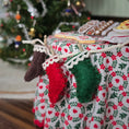 Load image into Gallery viewer, Decorative tablecloth with Christmas-themed stockings in a festive setting.
