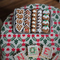 Load image into Gallery viewer, Decorative gingerbread cookies in a tin on a festive fabric background
