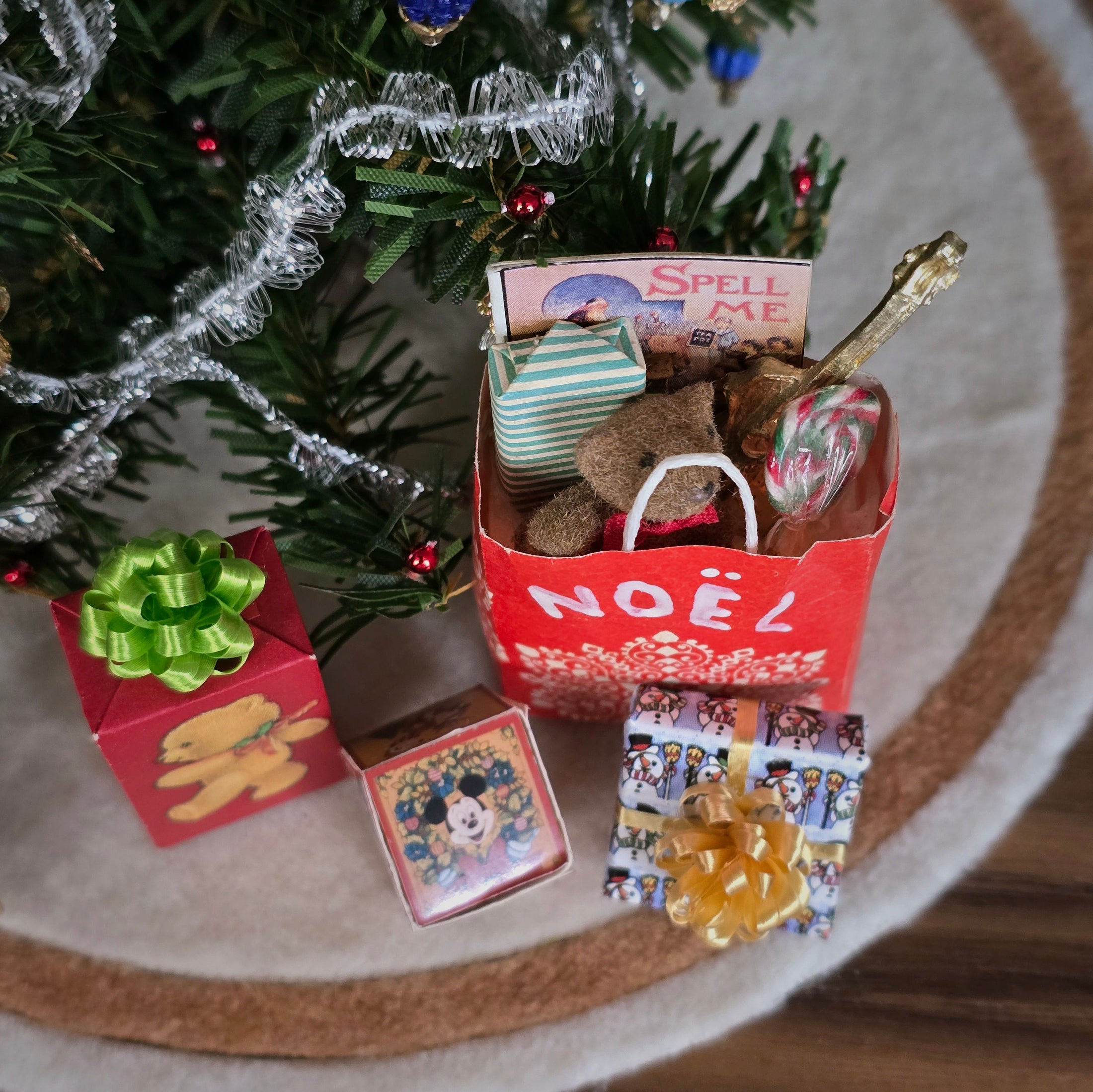 Miniature Christmas scene with toys and decorations on a tree