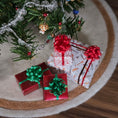 Load image into Gallery viewer, Small gift boxes with red and green ribbons under a Christmas tree.

