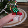 Load image into Gallery viewer, small wrapped gift balancing on a finger
