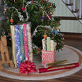 Load image into Gallery viewer, Gift wrap with ribbons and bow in front of a decorated Christmas tree.
