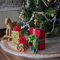 Load image into Gallery viewer, Dollhouse miniature Colorful Christmas presents with ribbons in front of a decorated Christmas tree.
