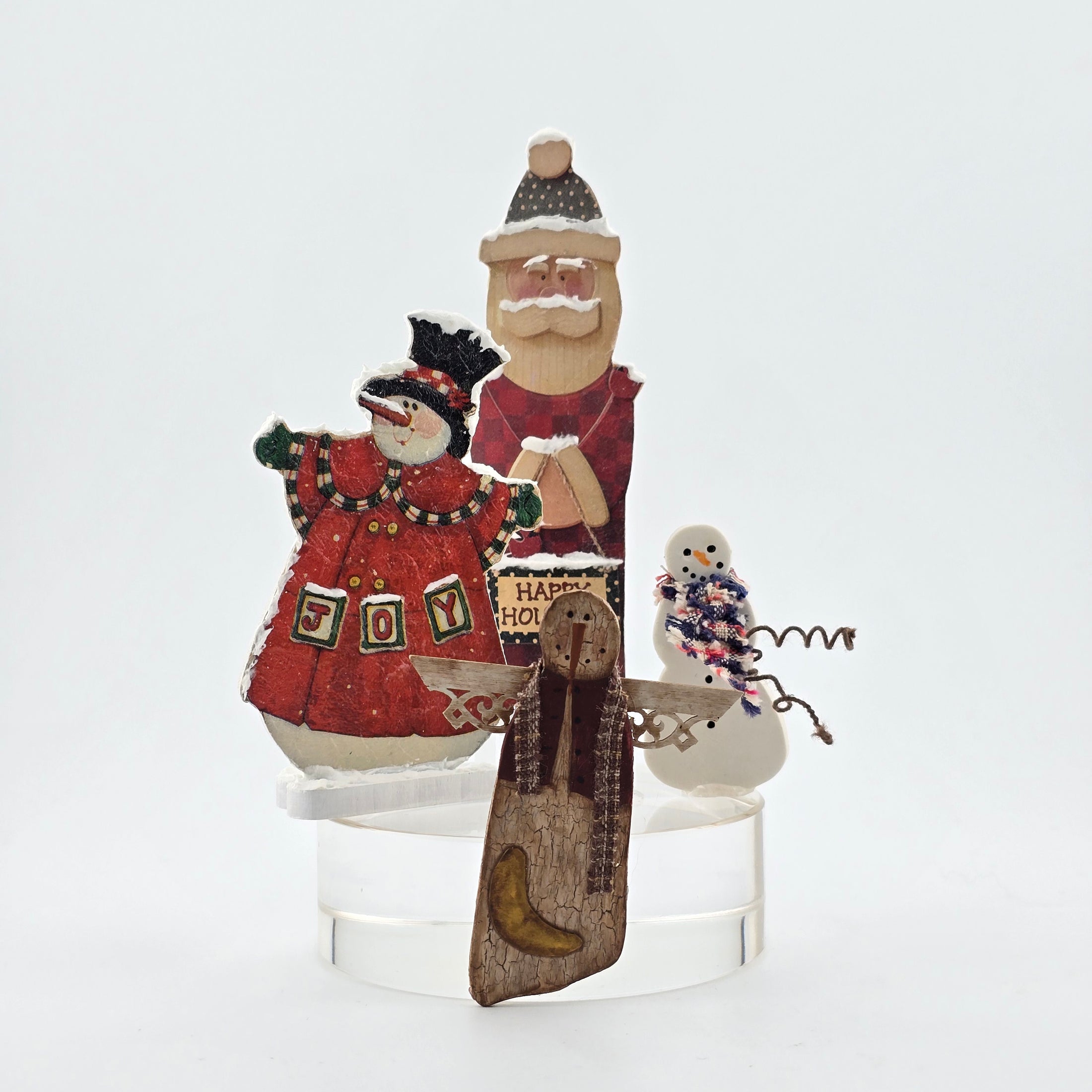 Dollhouse miniature Decorative Christmas figures including snowmen, and a Santa Claus on a white background.