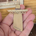 Load image into Gallery viewer, Signed backside of a Dollhouse miniature decorative angel snowman with intricate cut-out design held in a hand.

