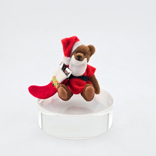 Dollhouse Teddy bear wearing a Santa outfit on a white background