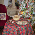 Load image into Gallery viewer, Decorative table setting with a tartan tablecloth, bowl, and cookies in front of a Christmas tree.
