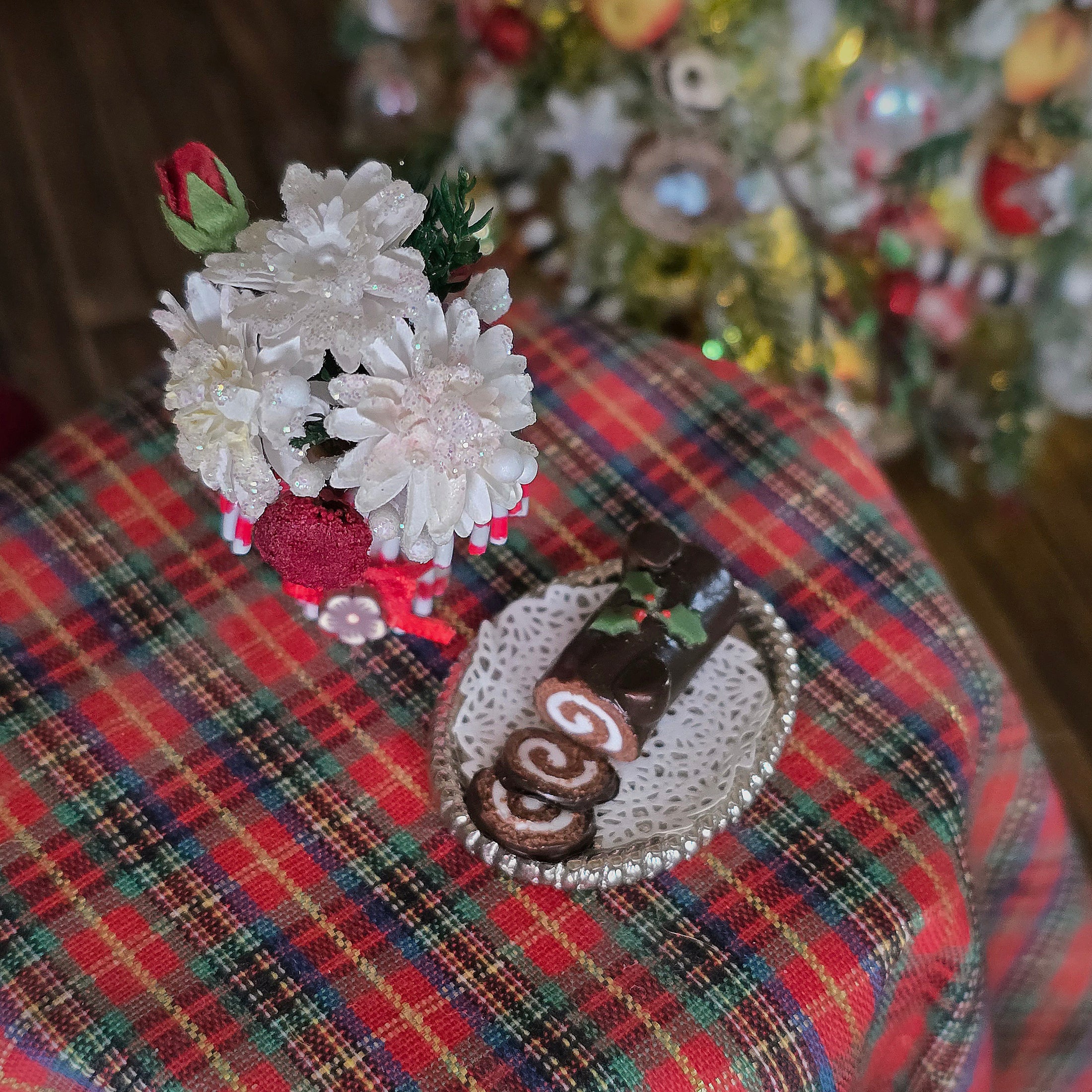 vase of flowers, yule log cake, top view