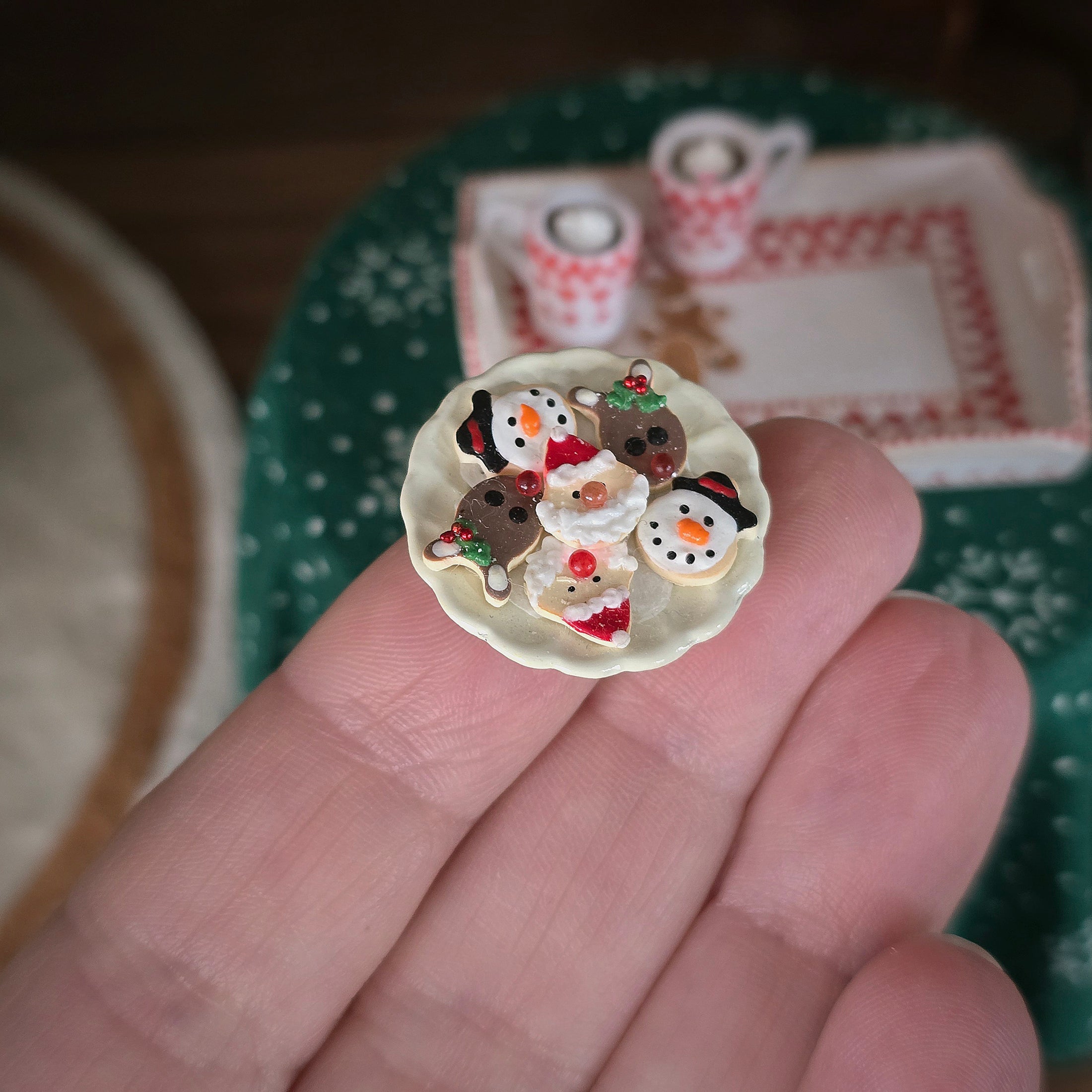 Small decorative plate with christmas cookies on a hand, with a blurred background