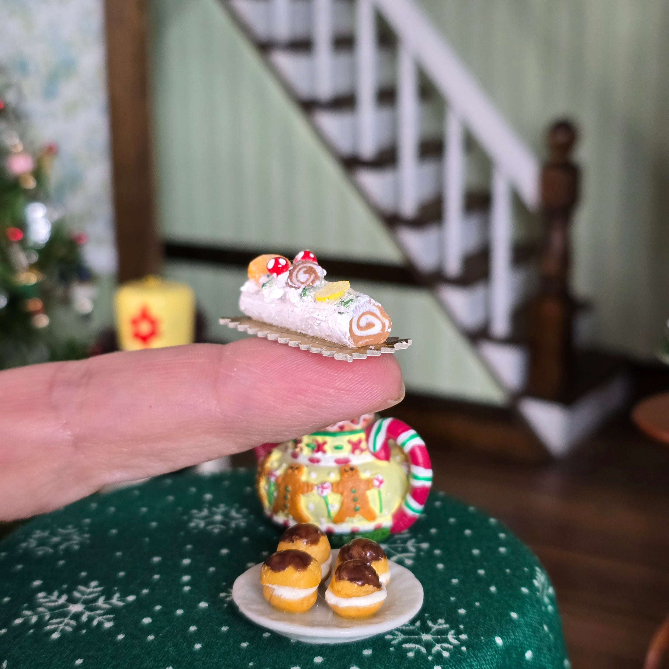 Miniature cake held by a hand with a festive background