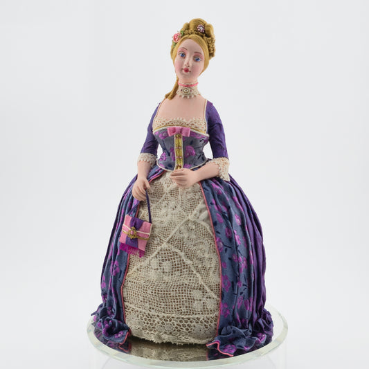 Gale Elena Bantock doll in a historical dress on a white background