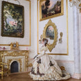 Load image into Gallery viewer, Stacy Hoffman doll in a dress standing in an ornate room with classical paintings and decor.
