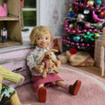 Load image into Gallery viewer, Catherine Muniere Doll with blonde hair and a floral top seated in a playroom
