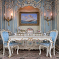 Load image into Gallery viewer, Opulent dining room with ornate table and chairs, decorative wall art, and lighting fixtures.
