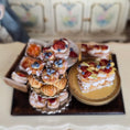 Load image into Gallery viewer, Decorative display of pastries on a wooden board.
