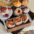 Load image into Gallery viewer, Assorted miniature pastries including strawberry tarts and croissants on a tiered stand.
