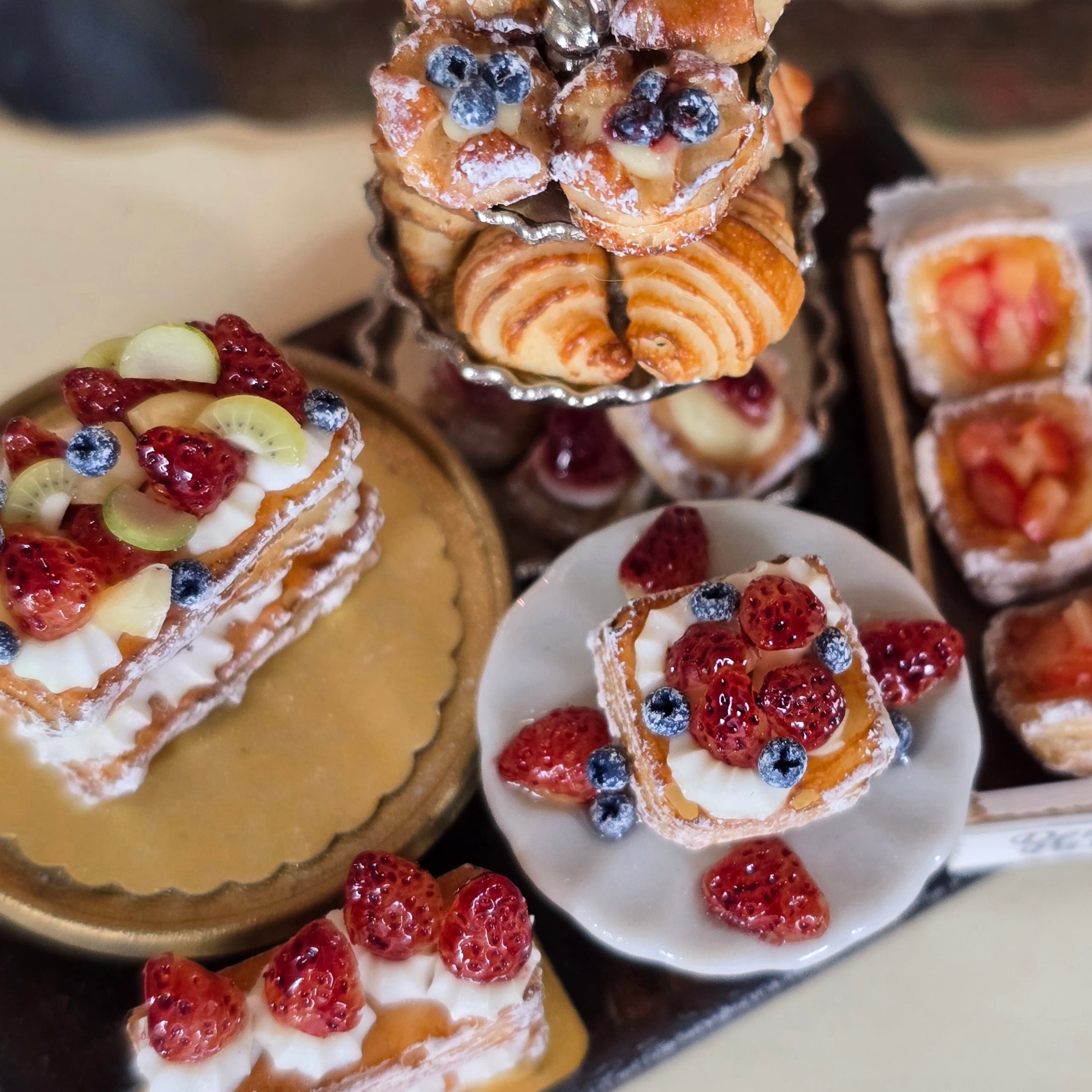 Assorted miniature pastries with fruit toppings on a table