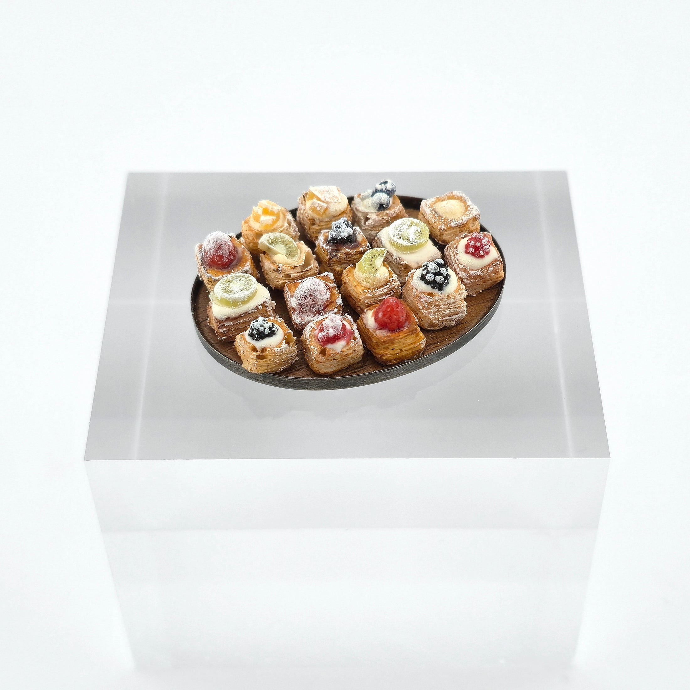 miniature pastries on wood platter